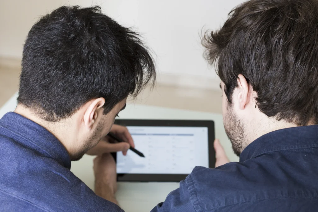 anonymous man discussing data tablet